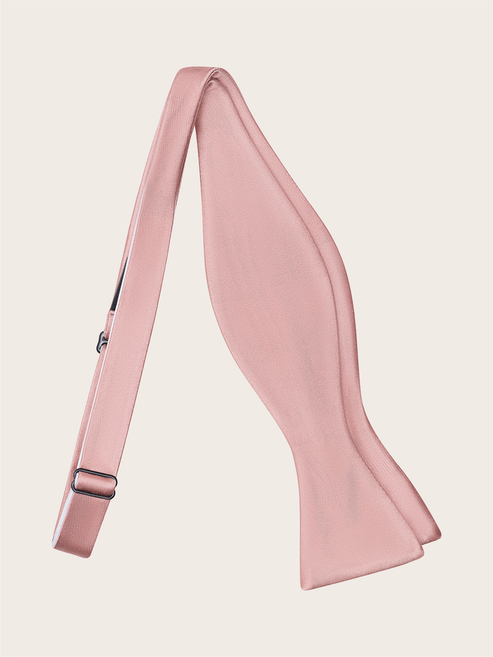 Untied dusty rose satin self-tie bow tie with adjustable strap, on a light background.