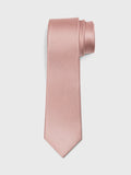 Dusty rose silk necktie rolled into a loose coil on a grey background.