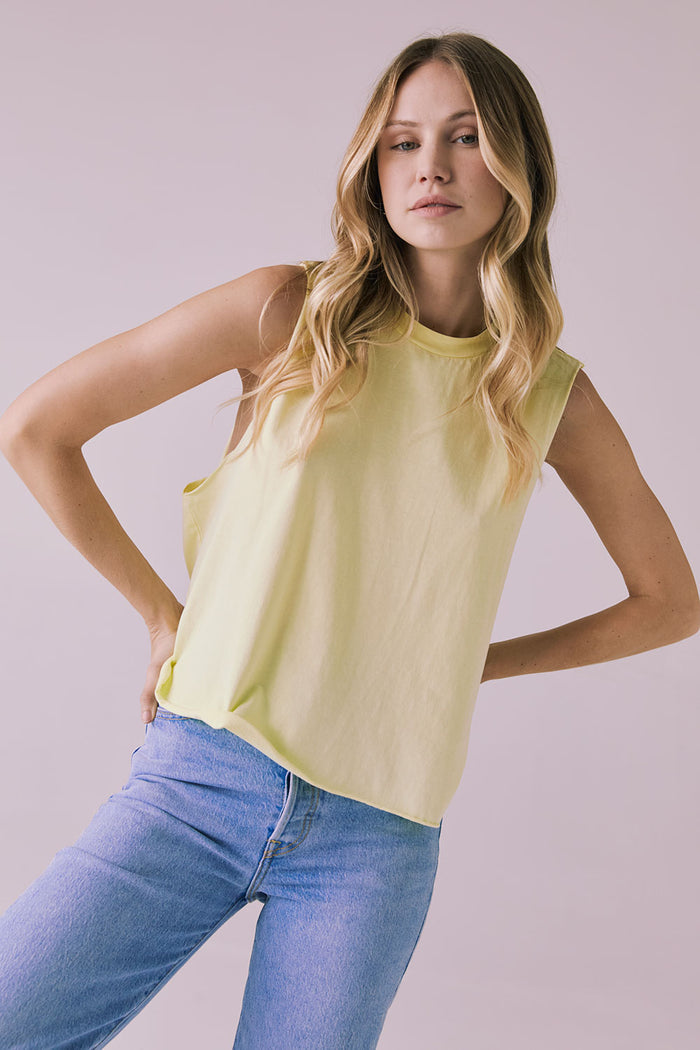 Front view of the Chaser Eagle Panna Cotta Tank styled with light-wash jeans, showcasing the soft yellow hue and easy sleeveless fit
