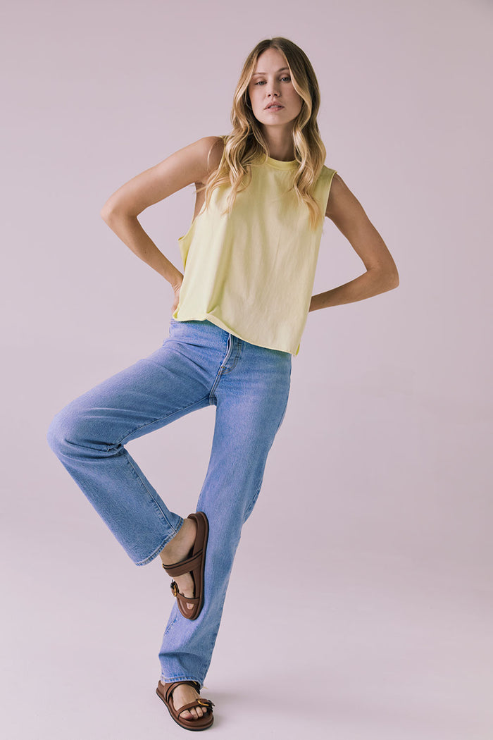 Full-length studio image of the Chaser Eagle Panna Cotta Tank paired with blue jeans and brown sandals for a casual, sunny-day vibe