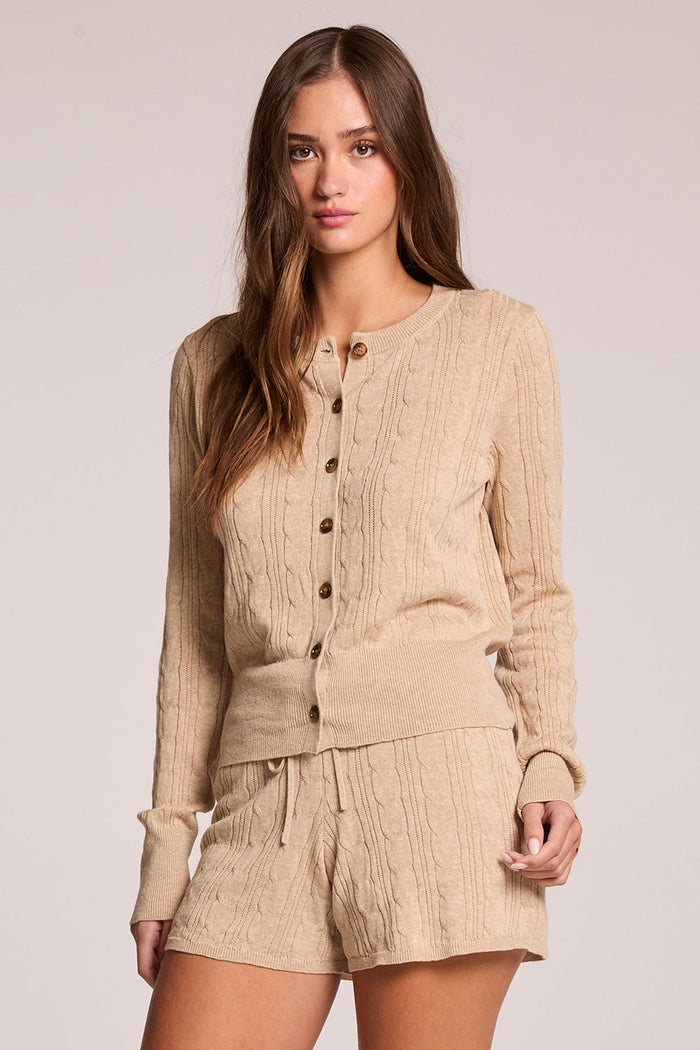Front view of a woman wearing the Chaser Eliza Khaki Cardigan and shorts on a neutral background