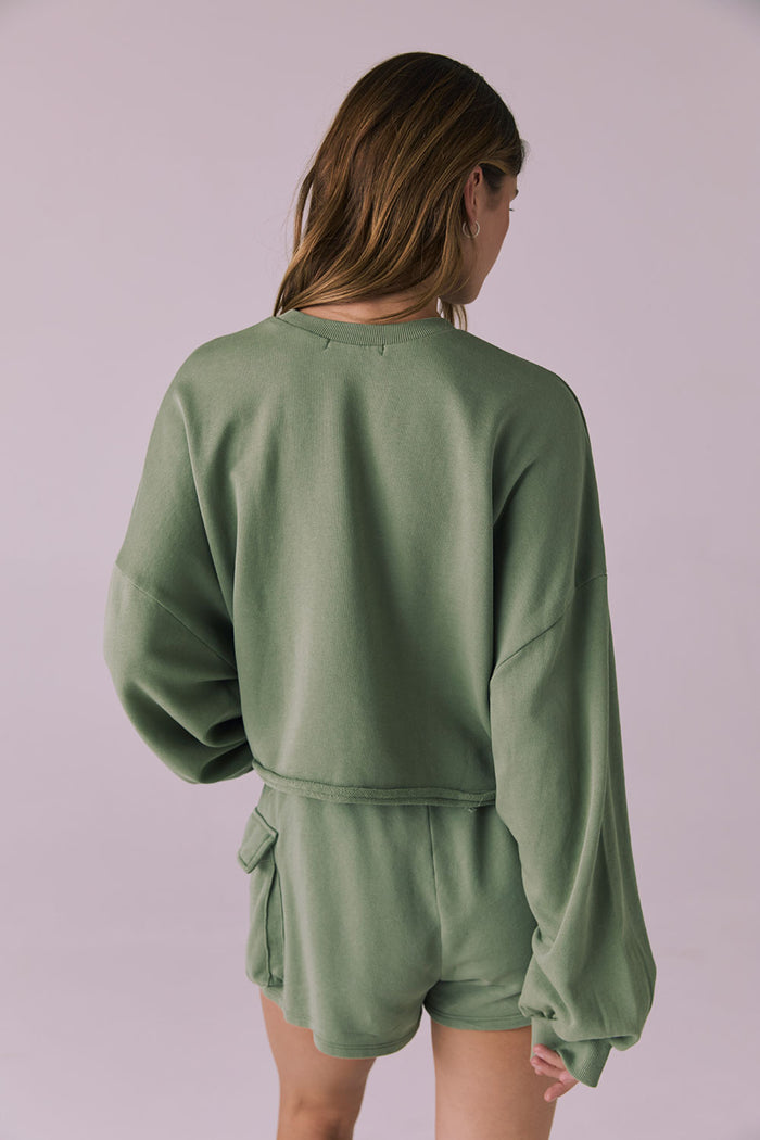Back view of the Chaser Eliza Meadow Green Crop Pullover showing the clean straight hemline and easy drape over the matching shorts