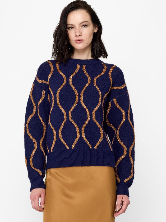 A woman wearing a navy and bronze Jumper with sequin embellishments, drop shoulders, long balloon sleeves, a ribbed high crew neck and a regular fit.