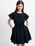 Woman wearing a poplin black mini dress, with flutter short sleeves, a crew neckline and a gathered waist