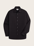 Black dress shirt laid flat, front view, showing spread collar and button placket.