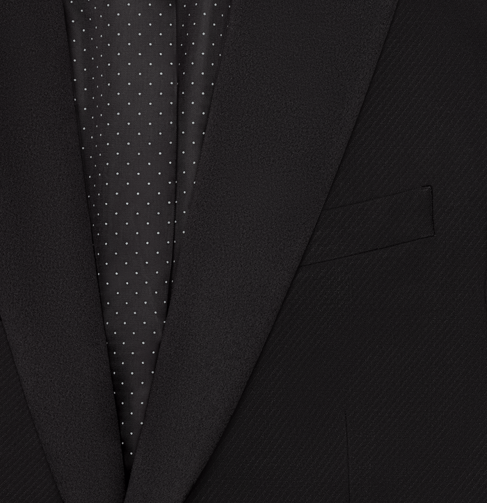 Close-up of black tuxedo jacket satin lapel and welt pocket, revealing polka dot lining.