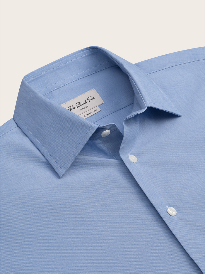 Close-up of light blue dress shirt collar and brand label.
