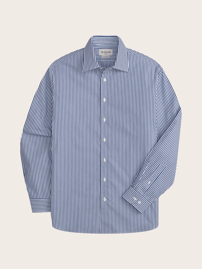 Navy and white striped dress shirt laid flat, showing spread collar and button placket.