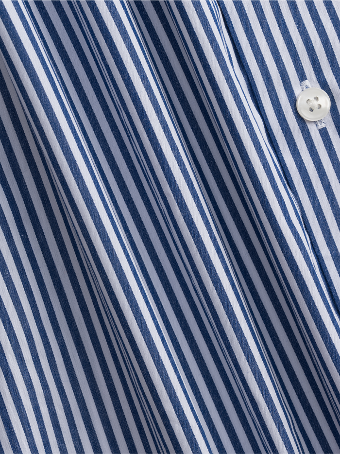 Close-up of navy striped dress shirt fabric with folds and a button.