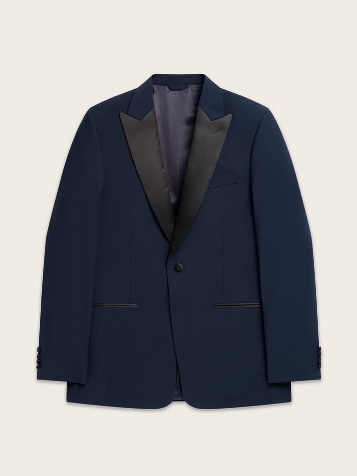 Navy tuxedo jacket laid flat, showing black satin peak lapels and welt pockets.