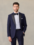 Man in a navy tuxedo jacket with black satin peak lapels and a black bow tie.
