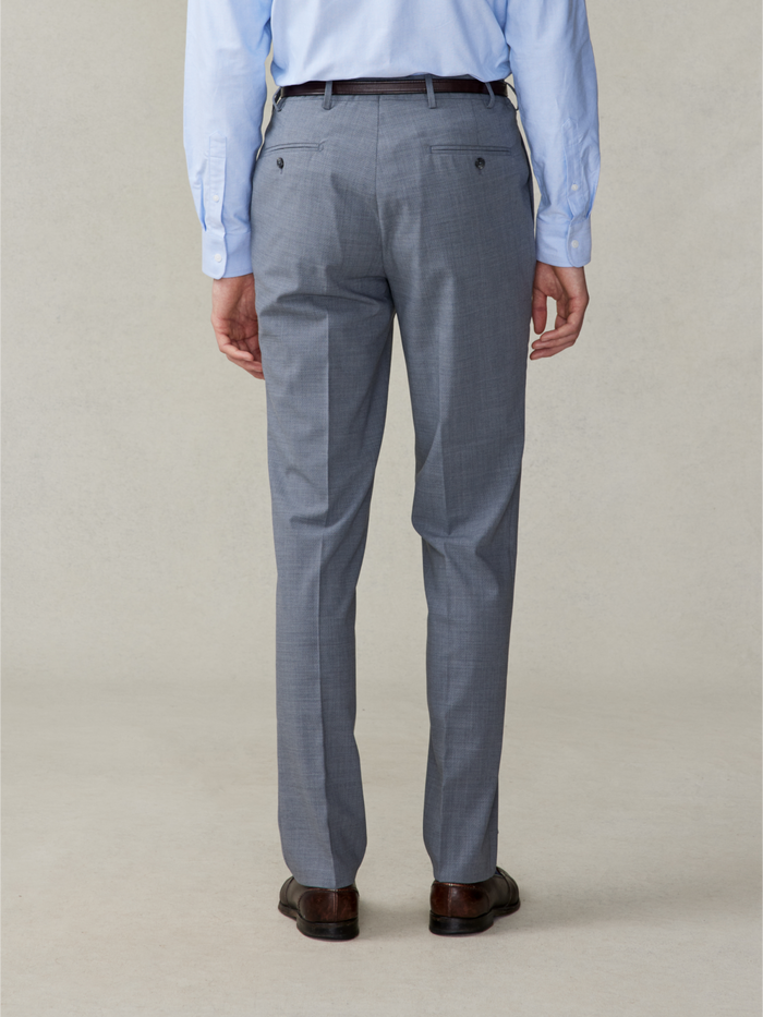 Back view of a man from waist down wearing slate grey trousers.