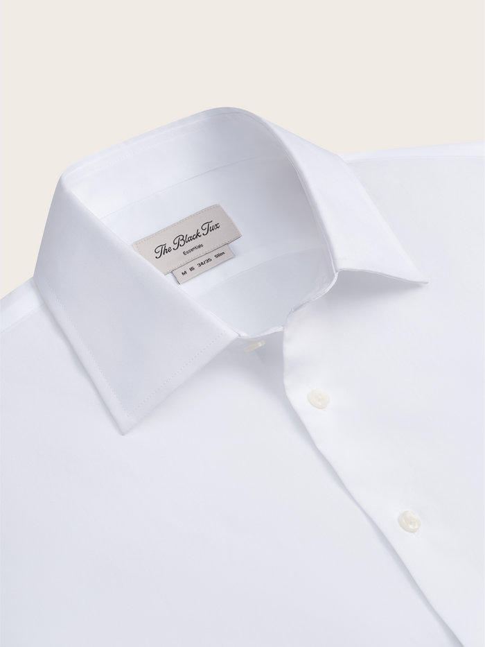 Close-up of a white dress shirt collar with the interior brand label.