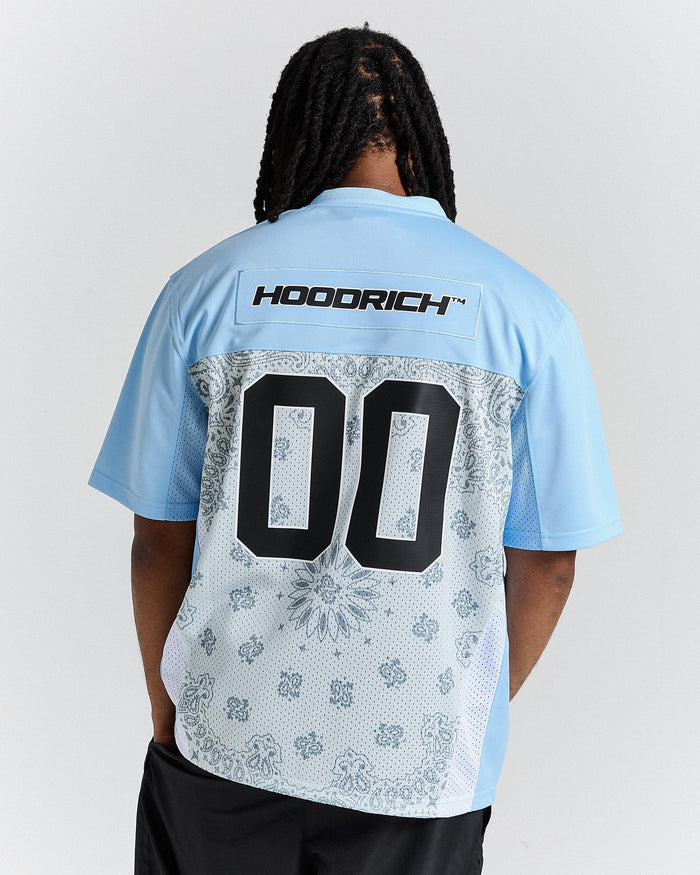 Person wearing a light blue sports jersey with 'HOODRICH' branding on the back.