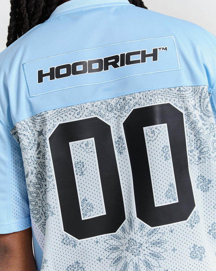 Light blue shirt with 'Hoodrich' branding and black numbers on the back.