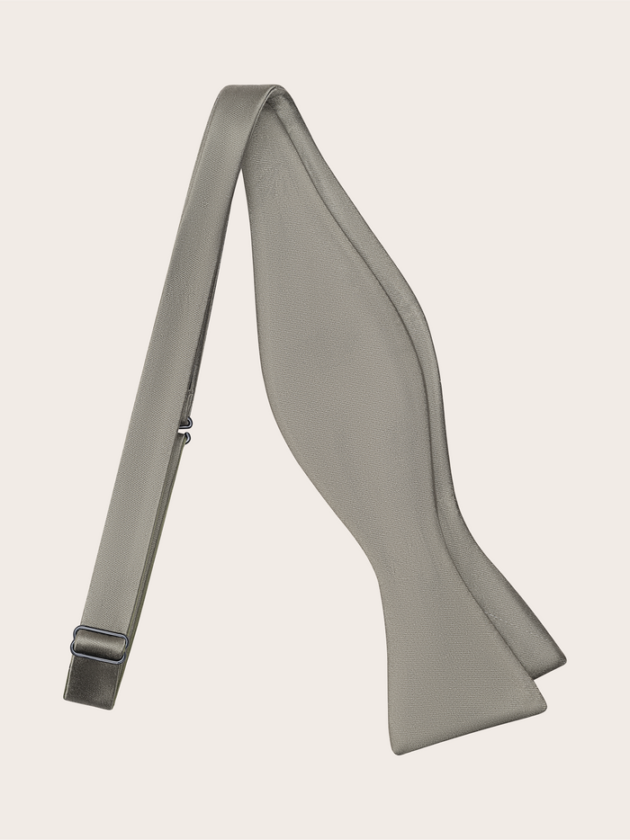 Light taupe satin self-tie bow tie, untied, showing the adjustable strap.