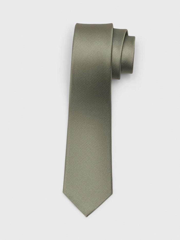 Eucalyptus silk necktie with twill texture, rolled at the top, on a grey background.