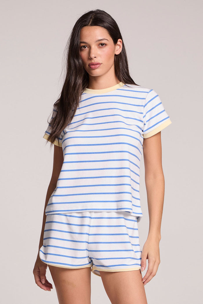 Front view of a woman wearing the Chaser  Evalina Blue Hydrangea Stripe Tee  and shorts on a neutral background