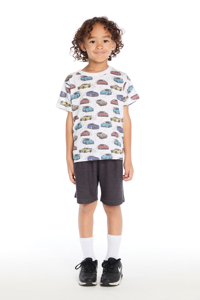Full body view of the Chaser Kids Fast Cars Tee in white with all-over colorful car graphics shown with the Vintage Black Cozy Knit Cozy Beach Short on a white background