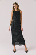Full body view of woman wearing Chaser’s Faye True Black Dress on a white background