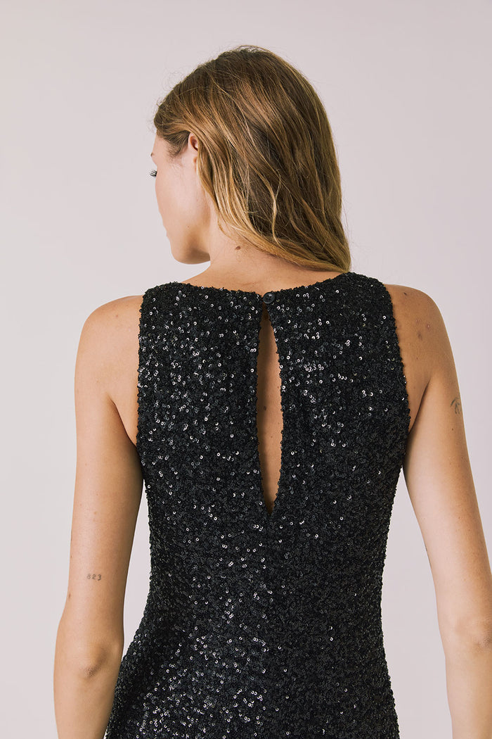 Back view of woman wearing Chaser’s Faye True Black Dress on a white background
