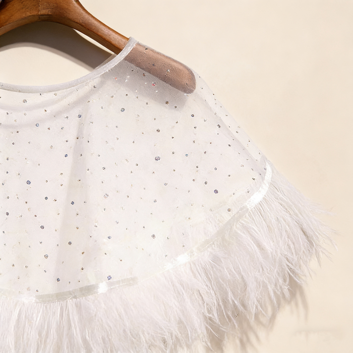 Feather bridal cape crafted from sheer chiffon with crystal embellishments and soft feather trim for wedding styling.
