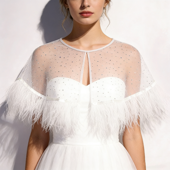 Feather bridal cape crafted from sheer chiffon with crystal embellishments and soft feather trim for wedding styling.
