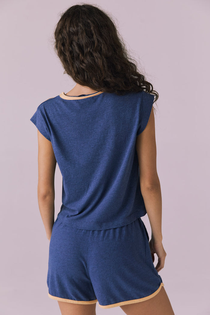 Back view of the Chaser Flora Cropped Honest Indigo Cap Sleeve Crewneck Tee paired with Taylorr Shorts highlighting the easy relaxed fit and soft blended fabric