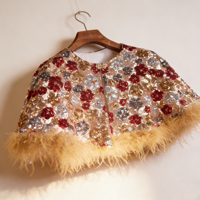 Handcrafted floral sequin bridal capelet featuring shimmering embroidery with soft faux fur trim in gold and burgundy.