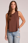 Front view of a woman wearing the Chaser  Flouncy Kahlua Muscle Tank and jeans on a neutral background