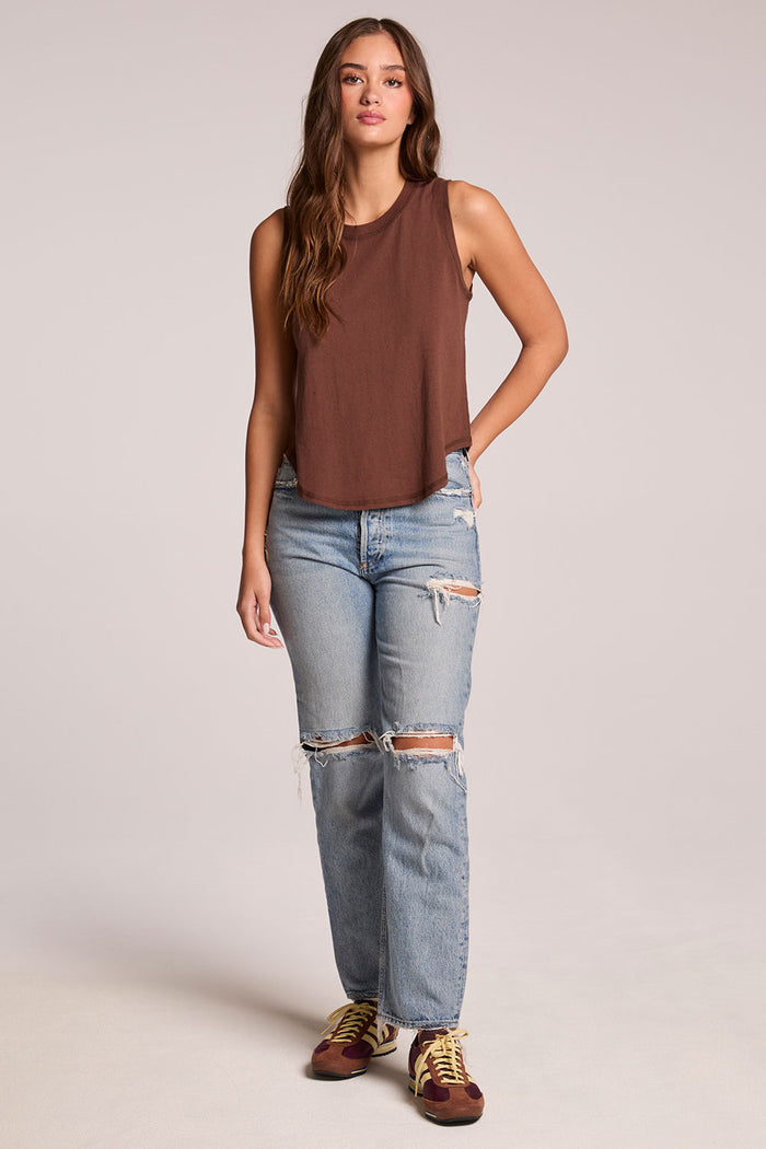 Front view of a woman wearing the Chaser  Flouncy Kahlua Muscle Tank and sneakers on a neutral background