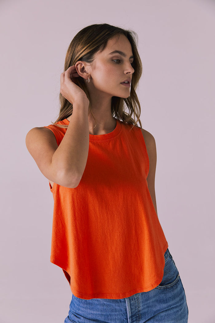 Angled studio image of the Chaser Flouncy Neon Flare Muscle Tank showing the soft structure and casual silhouette
