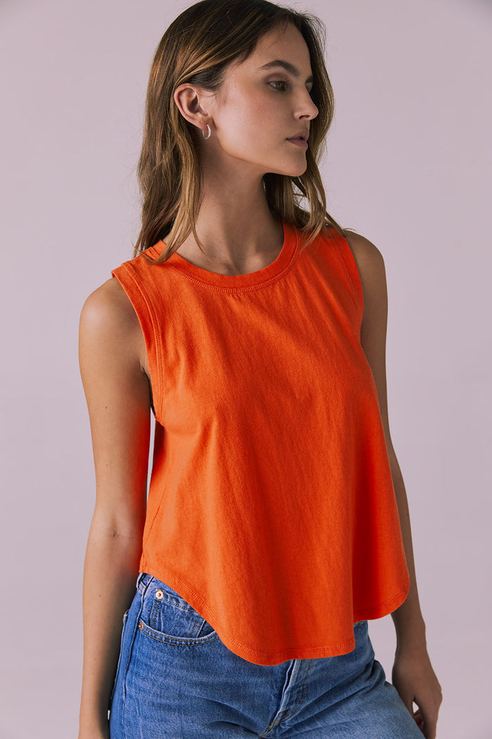 Side studio image of the Chaser Flouncy Neon Flare Muscle Tank highlighting the flared drape and sleeveless cut