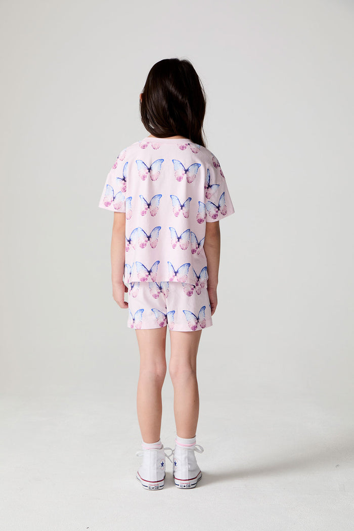 Full body back view of a girl wearing the Chaser  Flutter Butterfly Shorts on a neutral background