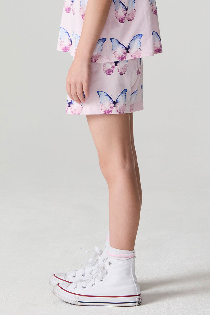 Side view of a girl wearing the Chaser  Flutter Butterfly Shorts and matching shirt on a neutral background