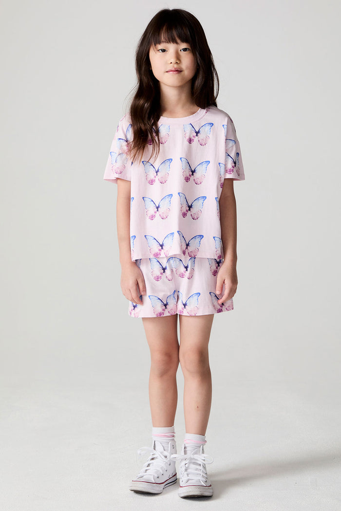 Full body front view of a girl wearing the Chaser Flutter Butterfly Tee and shorts on a neutral background