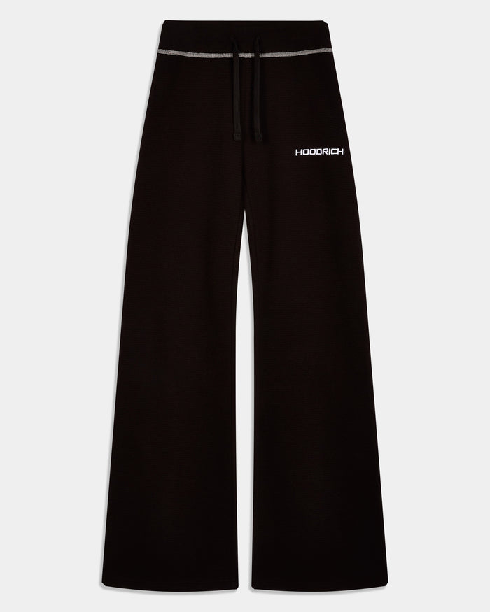 Black wide-leg sweatpants with a white drawstring and a white HOODRICH logo on the left hip, shown against a light gray background.