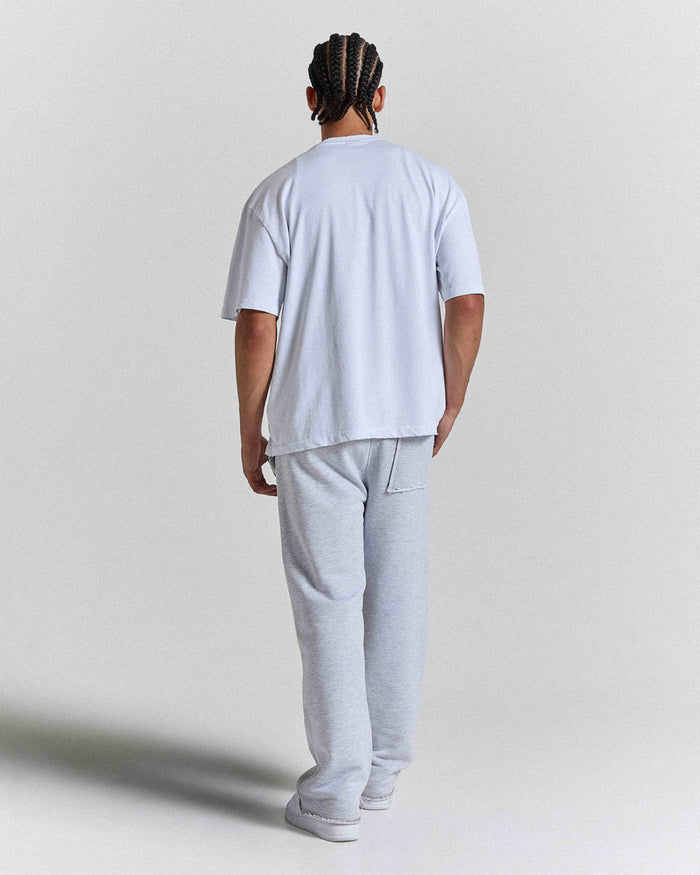 Back view of a male model wearing a regular-fit white Hoodrich t-shirt.