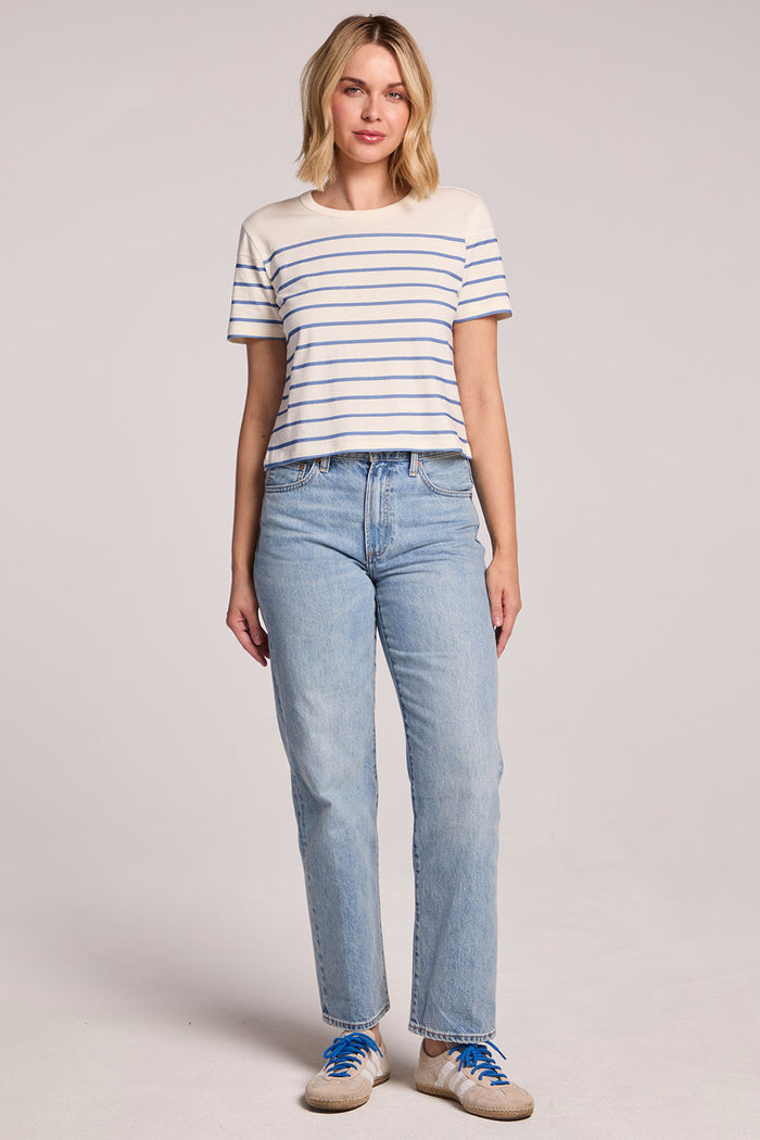 Full body front view of a woman wearing the Chaser French Riviera Stripe Jameson Tee and sneakers on a neutral background