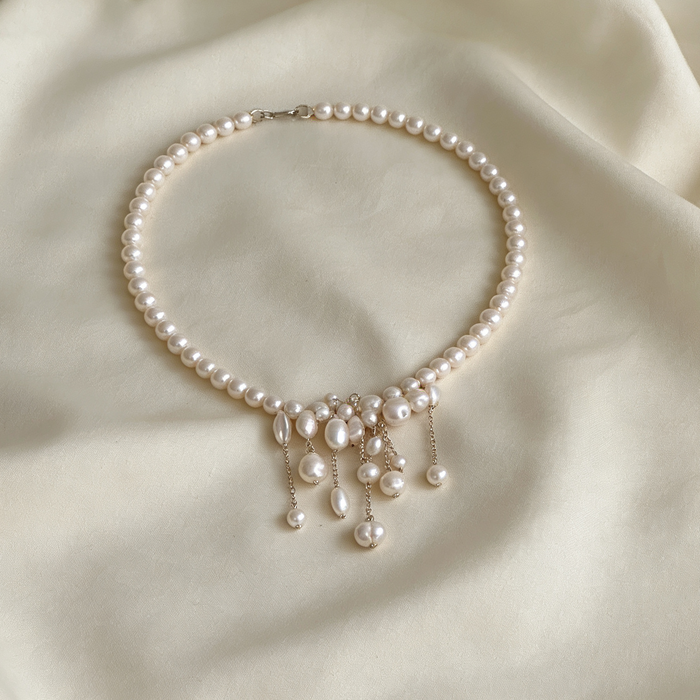Handcrafted freshwater pearl bridal choker necklace featuring natural baroque pearls and elegant cascading pearl tassels.