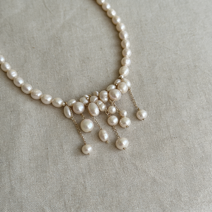 Handcrafted freshwater pearl bridal choker necklace featuring natural baroque pearls and elegant cascading pearl tassels.