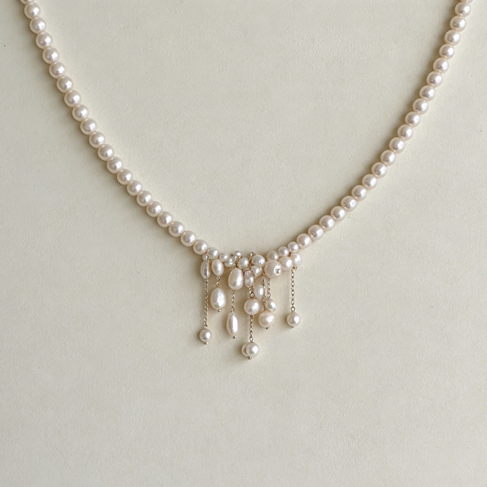 Handcrafted freshwater pearl bridal choker necklace featuring natural baroque pearls and elegant cascading pearl tassels.