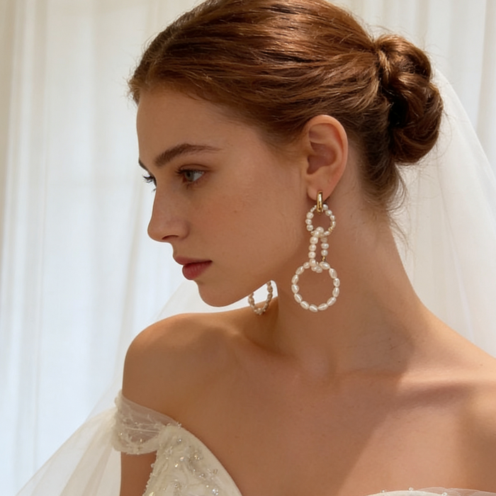 Handcrafted natural pearl wedding earrings worn by bride with timeless luxury bridal jewelry style