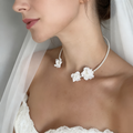 Handmade freshwater pearl bridal choker featuring delicate white resin flowers for an elegant wedding look.