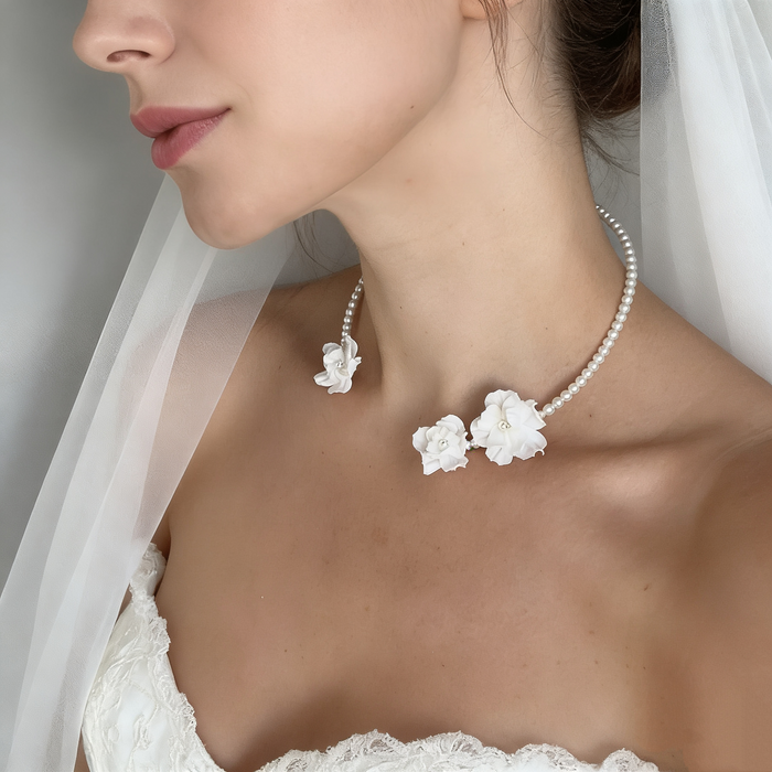 Handmade freshwater pearl bridal choker featuring delicate white resin flowers for an elegant wedding look.