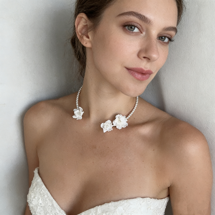 Handmade freshwater pearl bridal choker featuring delicate white resin flowers for an elegant wedding look.