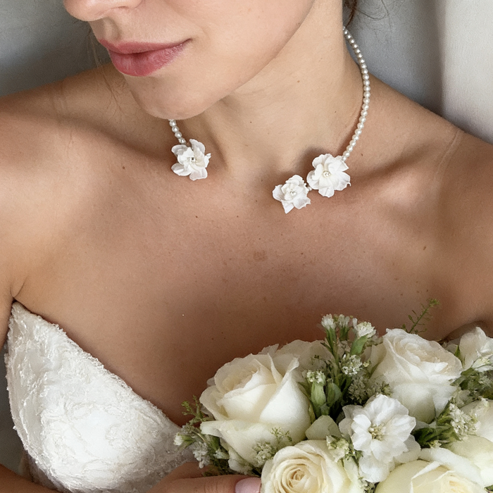 Handmade freshwater pearl bridal choker featuring delicate white resin flowers for an elegant wedding look.