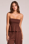 Front view of a woman wearing the Chaser  Frieda Kahlua Tube Top on a neutral background