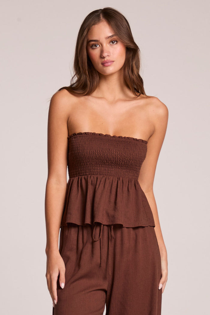 Front view of a woman wearing the Chaser  Frieda Kahlua Tube Top on a neutral background