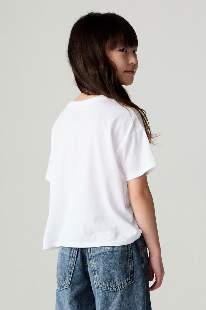 Back view of a girl wearing the Chaser Full Of Love Girls Tee on a neutral background with jeans